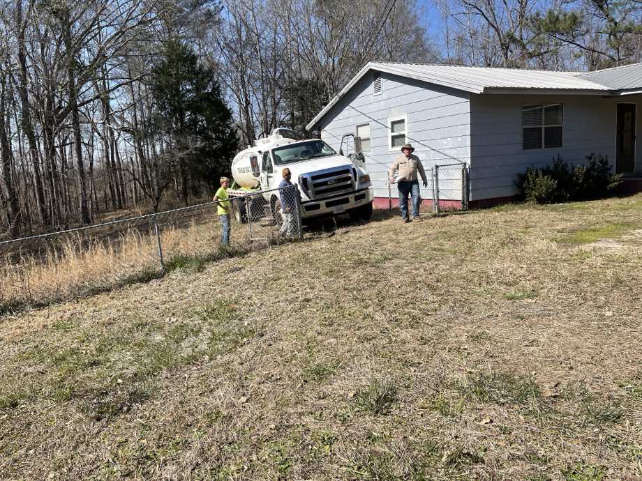 Mike Hogg Septic Tank Inc pump truck on the job